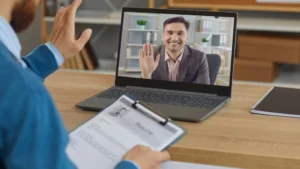 A man on a laptop screen on an online meeting